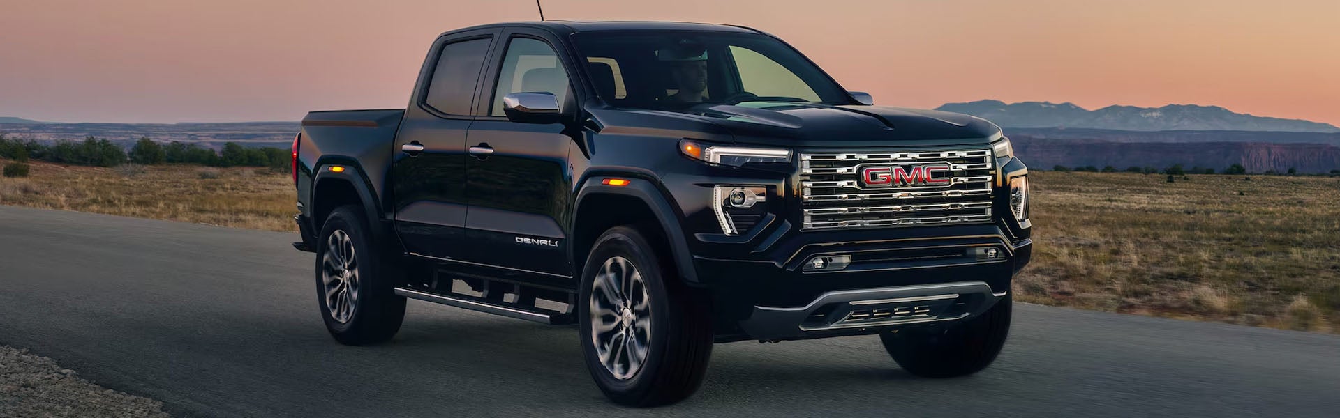 2026 GMC Canyon red pickup truck hero image front three-quarter view outdoors