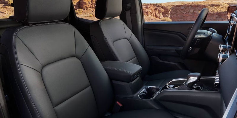 2026 GMC Canyon premium front cabin with black leather seats and center console