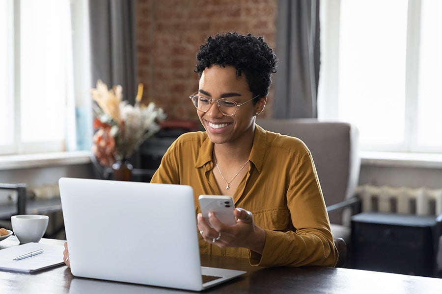 Person using a computer and phone